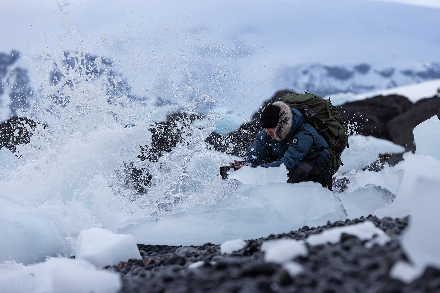 Photographer Artem Shestakov capturing waves crushing on ice in Antarctica. 